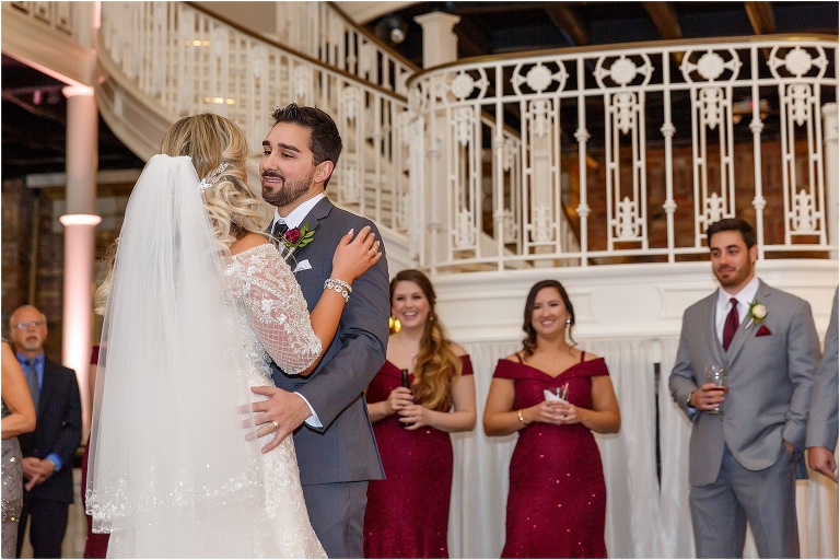 the groom looks lovingly at his bride as they share their first dance as husband and wife