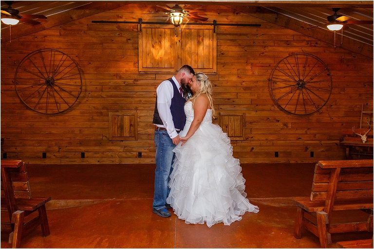the bride & groom share a quiet moment in the wooden chapel alone at night