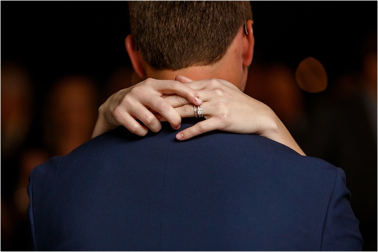 the bride's stunning Ackerman Jeweler's engagement ring sparkles in the light during their first dance as husband and wife