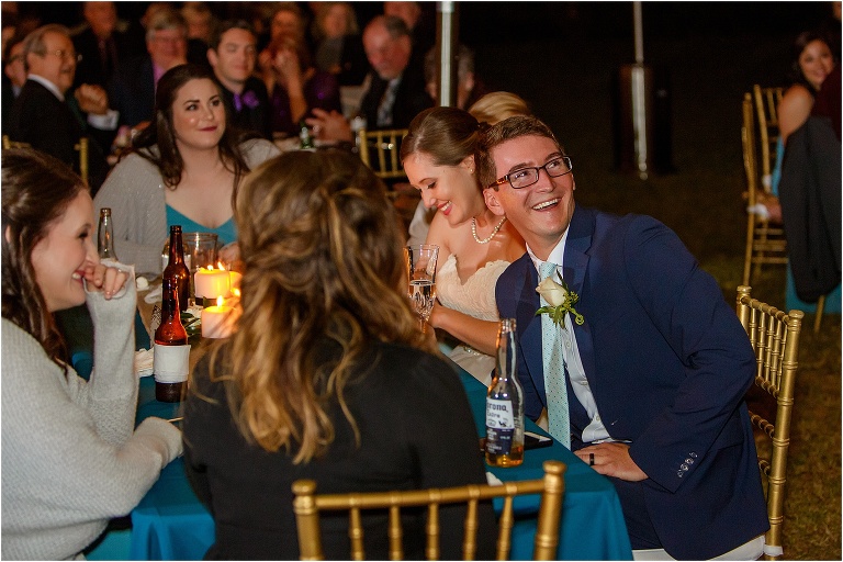the groom laughs as his best man delivers his toast at their Davis Island Yacht Club reception