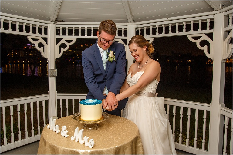 The bride and groom cut their Sweet! By Holly red velvet cake