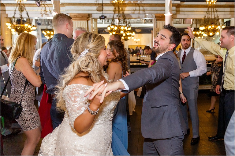 the bride and groom dance to the epic dance mix from Fyerfly Productions surrounded by their guests