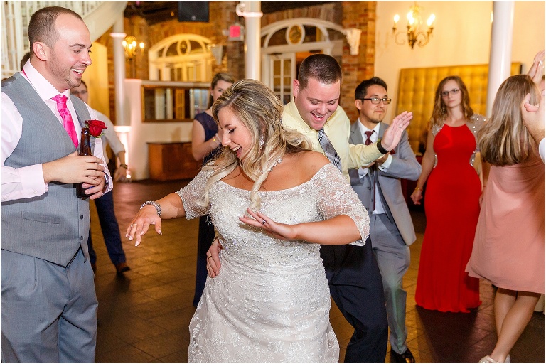 the bride dancing with her friends at their Orchid Garden wedding reception