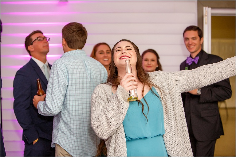 A bridesmaid singing her heart out using a Corona bottle for a microphone during their Davis Island Yacht Club reception
