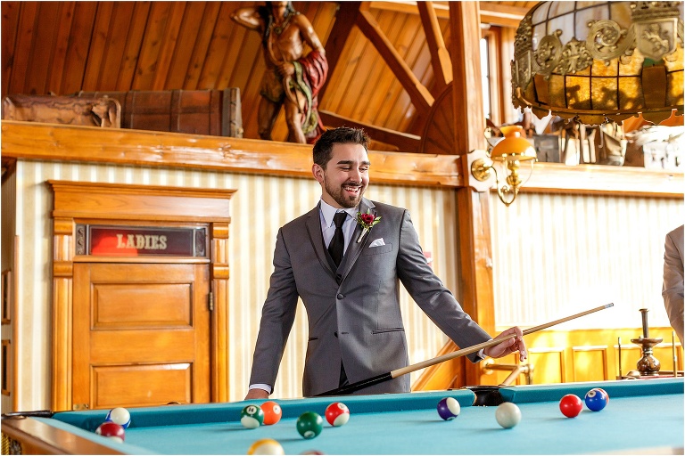 the groom shoots pool at the historic Cheyenne Saloon in Downtown Orlando