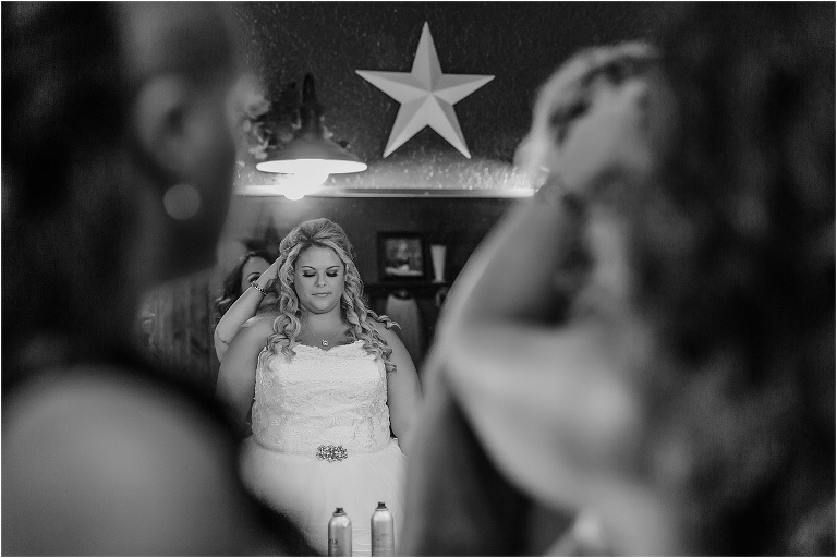 the bride finishes doing her hair before her Hidden Barn Venue ceremony