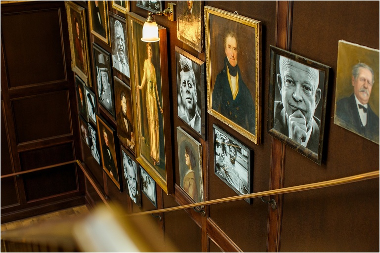 Portraits of historical figures hang along the stairs at the Oxford Exchange in Tampa