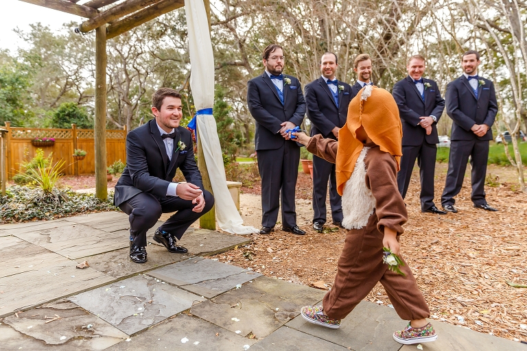 the ring bearer comes down the aisle in his Ewok costume from Star Wars 
