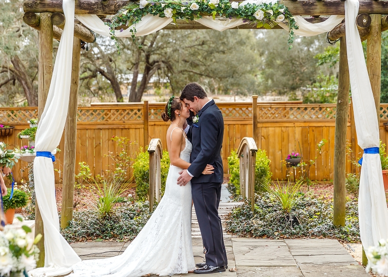a moment of calm after their first kiss as husband and wife during their DIY garden wedding
