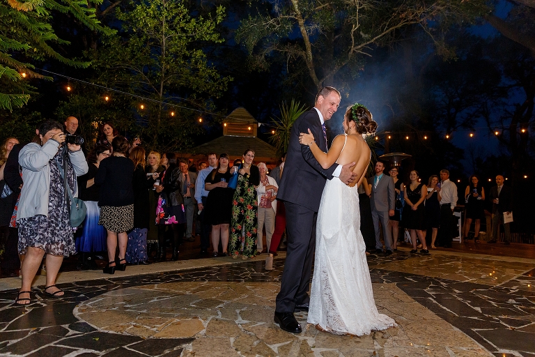the bride and her father laugh as they share their father daughter dance