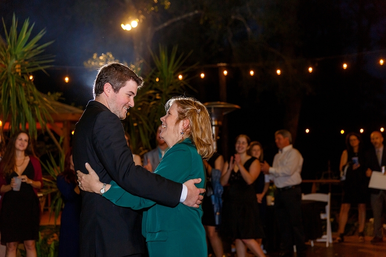 the groom and his mother laugh during their mother son dance to "Take Me Out to the Ballgame"