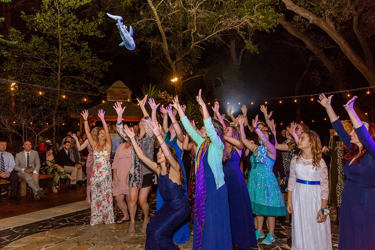 the bride threw a stuffed shark instead of her bouquet to match her love of sharks at their DIY garden wedding reception