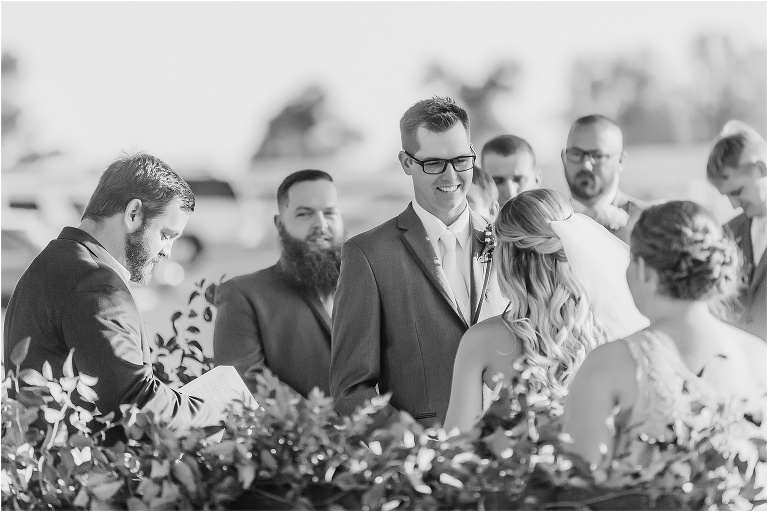 the groom looks lovingly at his soon to be wife during their Cottom Farm wedding ceremony