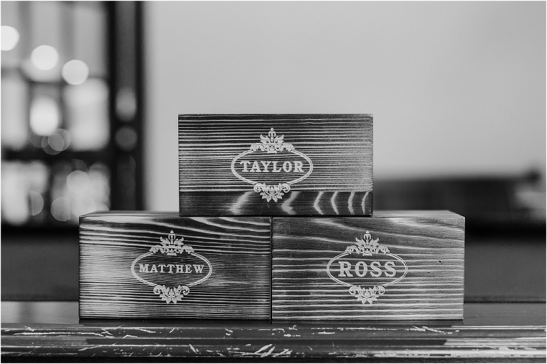 personalized wooden boxes gifted to the groomsmen stacked on the pool table