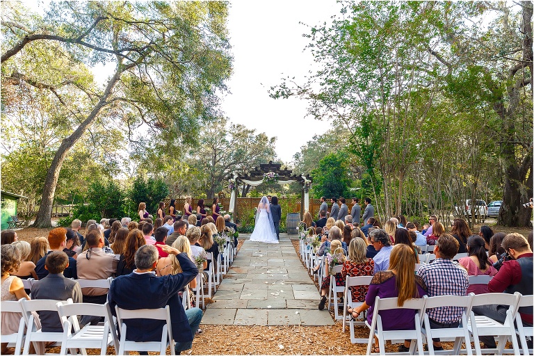 bride & groom face the alter as their loved ones look on