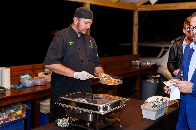 Harmony N Love sous chef serves delicious baked ziti to wedding guests
