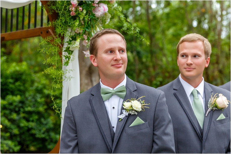 the groom & his best man both have tears in their eyes as the bride comes down the aisle