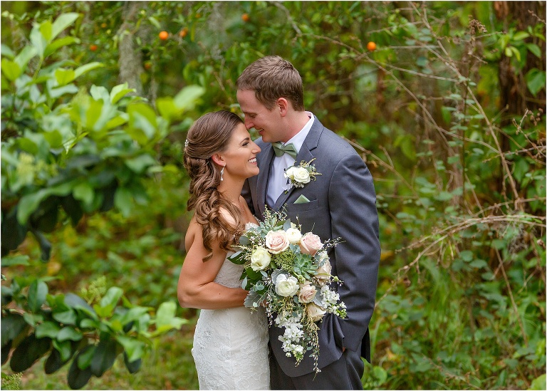 the groom nuzzles his bride during their first look before their Bakers Ranch wedding