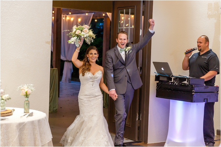 the bride and groom cheer as they are announced into their Bakers Ranch wedding reception