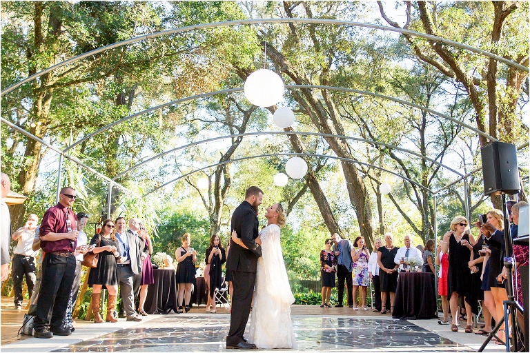 bride & groom share their first dance on the mosaic tile dance floor at Harmony Gardens wedding venue