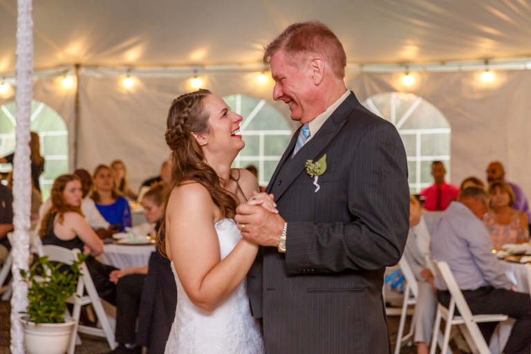 the bride and her father laugh as they share a dance at the Bellemoor Plantation wedding reception