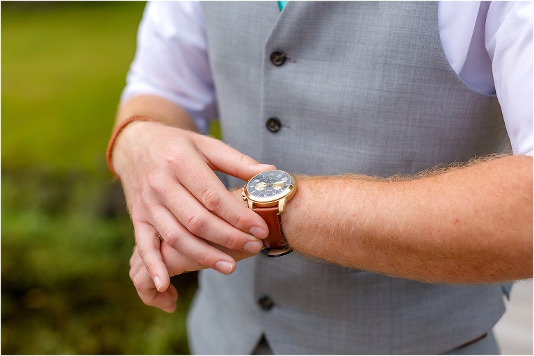 the groom checks his new watch from his bride before their Bellemoor Plantation wedding