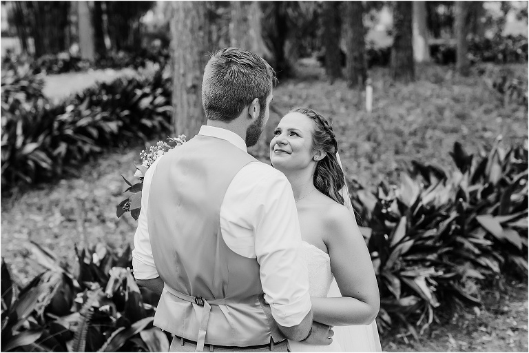 the bride looks lovingly at her groom with tears in her eyes during their first look