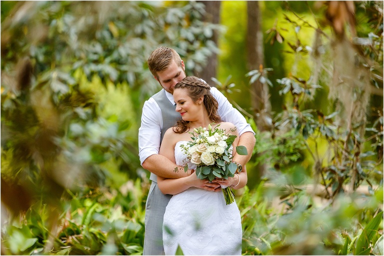 the groom wraps his bride up in his arms before their Bellemoor Plantation wedding