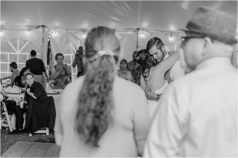 a peek through the guests as the bride and groom share their first dance during their Bellemoor Plantation wedding reception