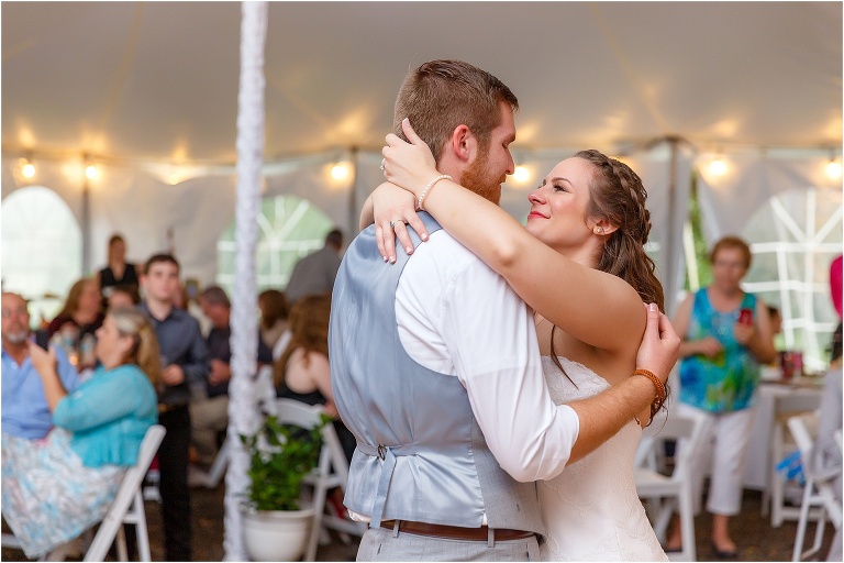 the bride looks lovingly at her new husband as they share their first dance