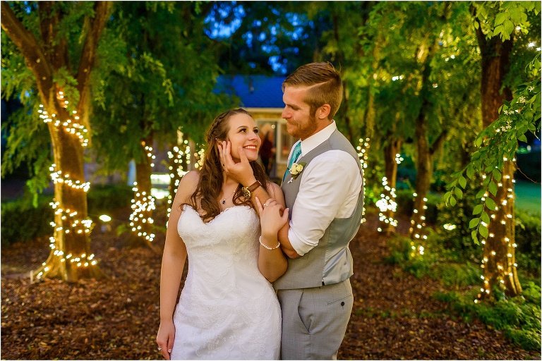 the bride & groom share a moment among the twinkle light adorned trees during their Bellemoor Plantation wedding