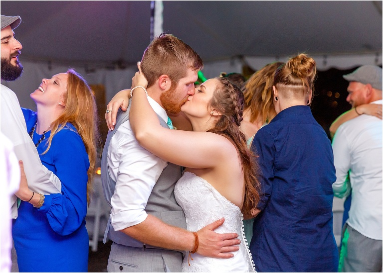 the bride and groom share a kiss while they dance during a slow moment at their Bellemoor Plantation wedding reception