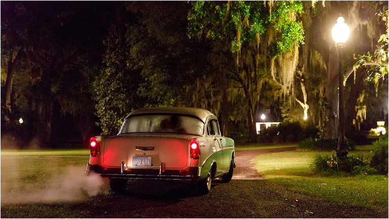 the bride and groom make their grand exit getaway in a mint green Bel Air at the end of their Bellemoor Plantation wedding