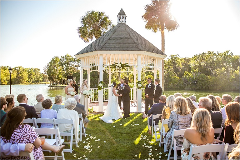the sun shines over their crystal river wedding as their loved ones look on
