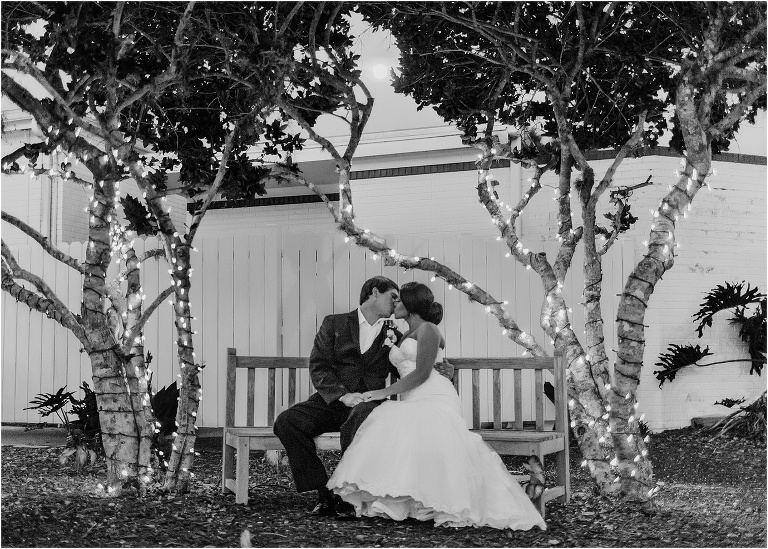 the bride and groom kiss under the twinkle lights at their crystal river wedding