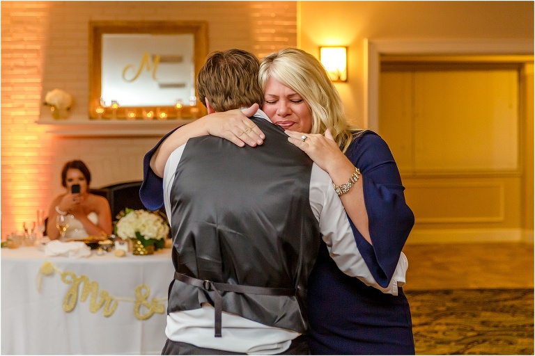 the mother of the groom gets emotional as she dances with her son at his crystal river wedding reception