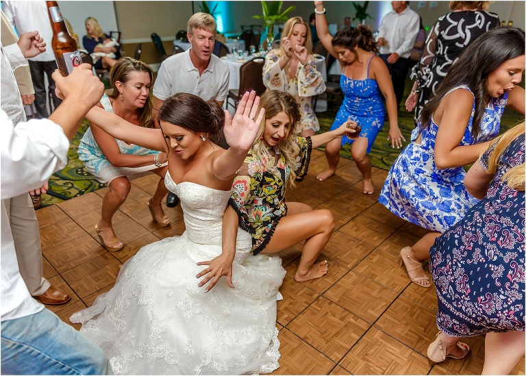 the bride gets low with her guests during their Crystal River wedding reception