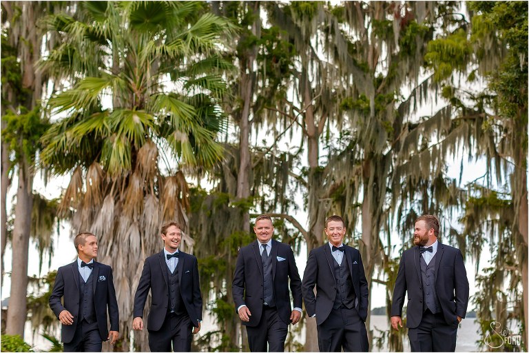 groom & groomsmen stroll together along Little Lake Harris at Mission Inn wedding