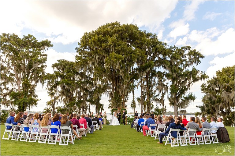 huge trees line Little Lake Harris at their Mission Inn wedding ceremony