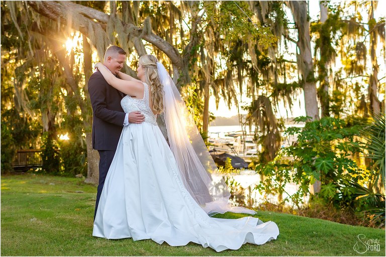 bride and groom hold each other after Mission Inn wedding on Little Lake Harris