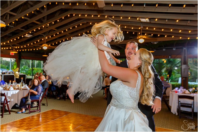 bride throws daughter into air as she shares first dance with the couple at Mission Inn wedding reception at Marina Del Rey