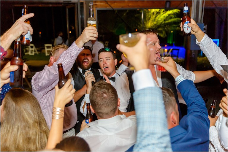 guests all raise a glass on the dance floor as they celebrate at Mission Inn wedding at Marina Del Rey