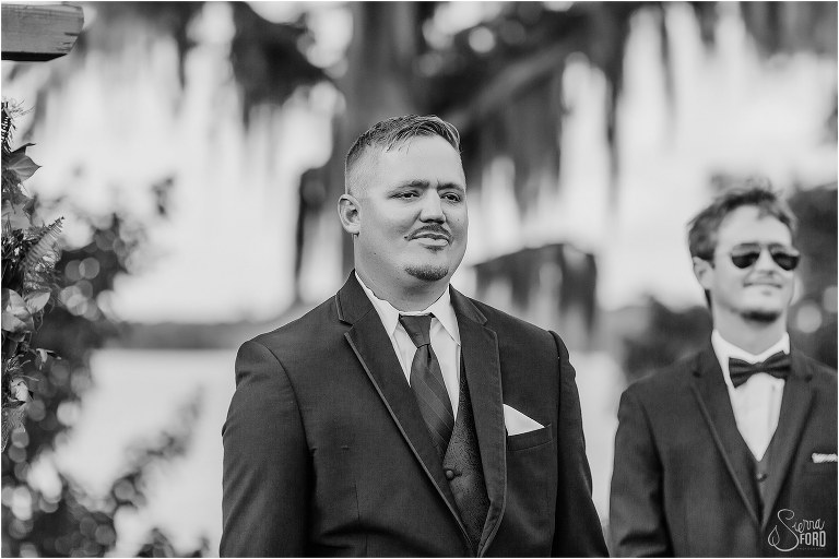 groom sees his bride coming down the aisle for the first time at Mission Inn wedding at Marina Del Rey