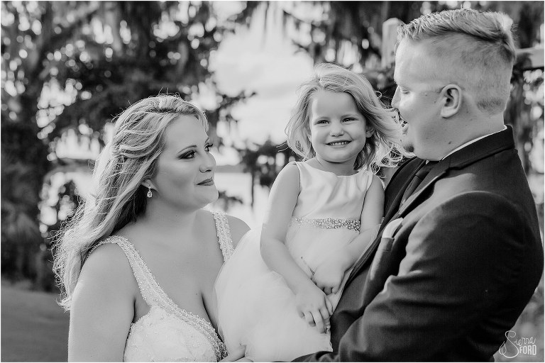 bride & groom look lovingly at daughter after Mission Inn wedding