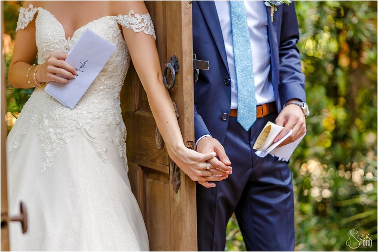 bride & groom hold hands during emotional first touch before their Club Lake Plantation wedding