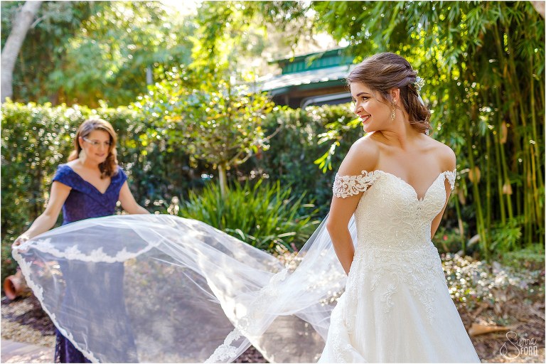 mother of the bride helps arrange bride's veil before Club Lake Plantation wedding