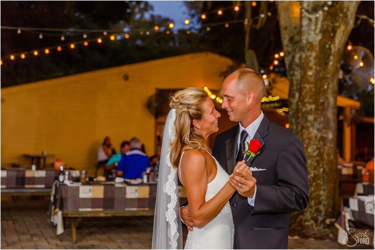 bride & groom smile at each other during first dance as husband and wife at Central Florida winery wedding