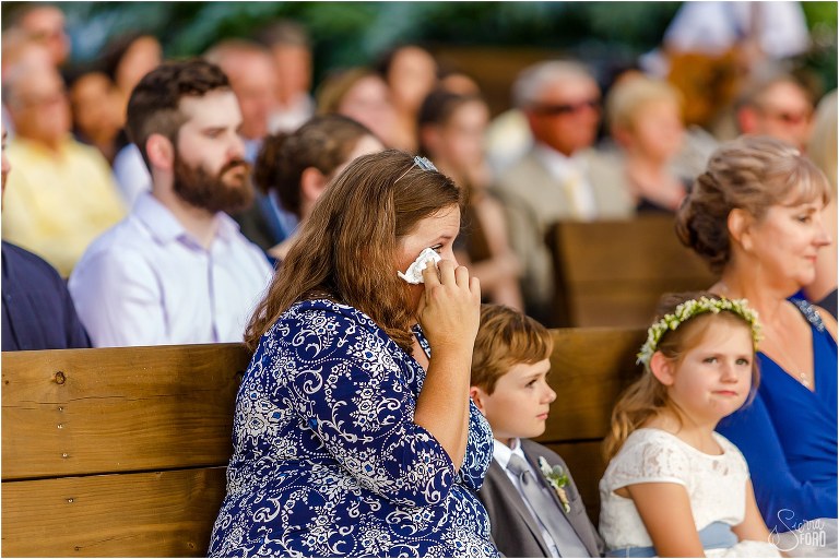guest wipes tears during emotional Club Lake Plantation wedding ceremony