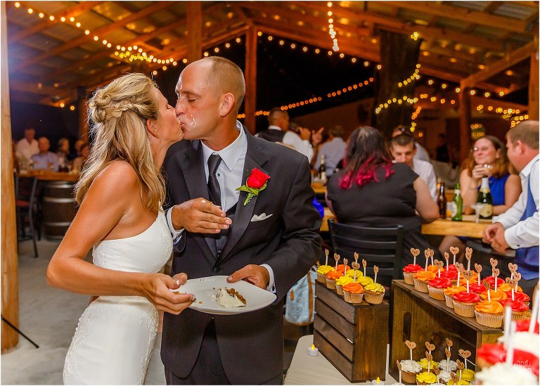 bride & groom kiss with cake covered faces at Central Florida winery wedding