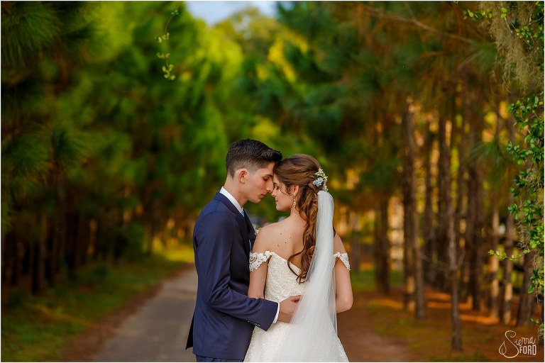 bride & groom forehead to forehead among the trees at Club Lake Plantation wedding